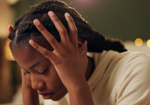 Black girl, thinking and sad or crying in home for academic pressure, self esteem or anxiety and de